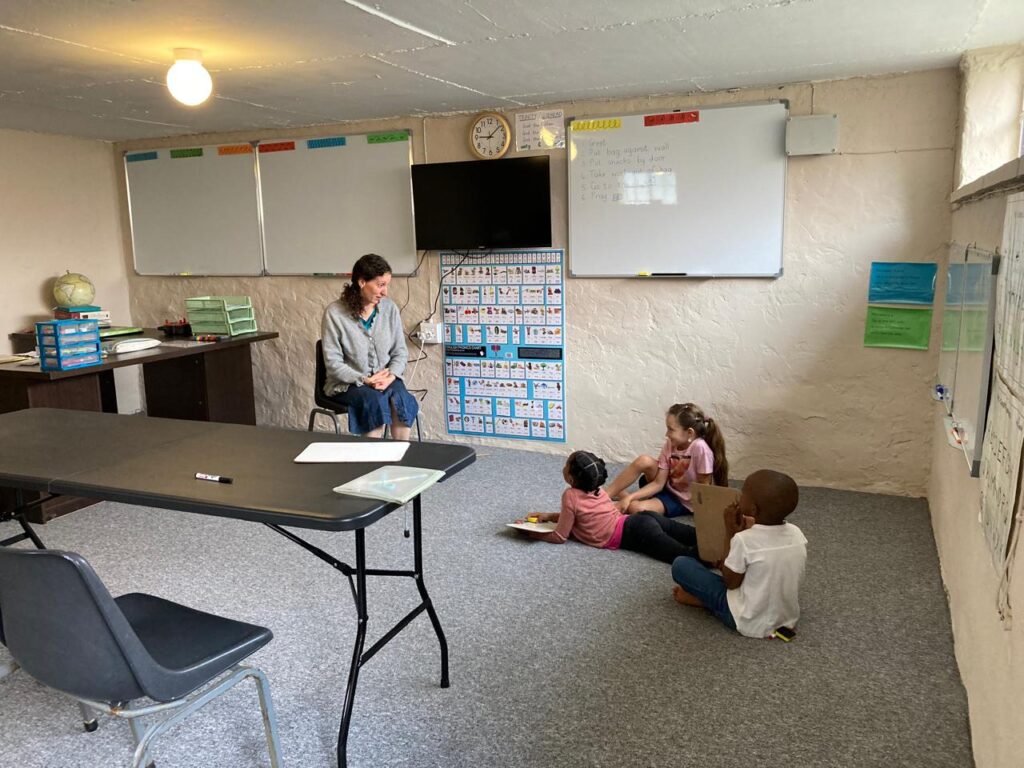 A teacher with young children in a Grammar-stage class